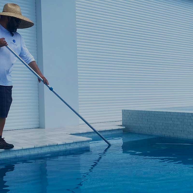 CPO (certified pool operator) vacuuming swimming pool during pool maintenance service | Sapphire Pools of Florida, Inc.