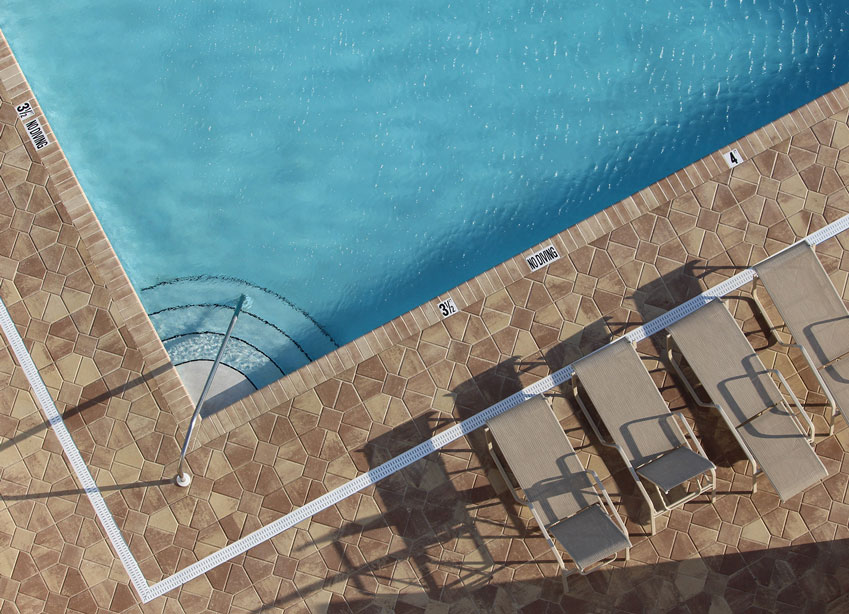 HOA community swimming pool aerial view with lounge chairs | Sapphire Pools of Florida, Inc.